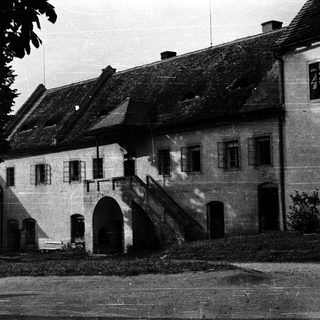 Historic stone building with arched entrance.