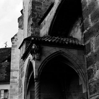 Gothic stone carving on historic building facade.