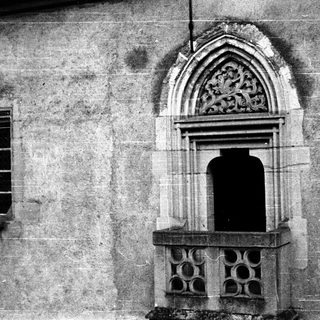 Gothic stone doorway with pointed arch and decorative carvings.