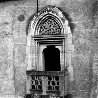 Gothic stone doorway with pointed arch and decorative carvings.