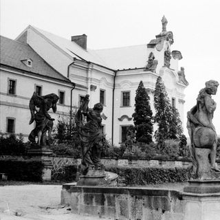Baroque-style fountain with classical statues in courtyard.