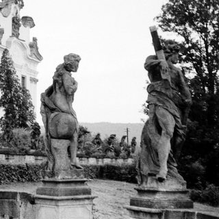 Baroque-style fountain with classical statues in courtyard.