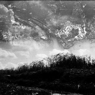 Destructive mushroom cloud over flat landscape.