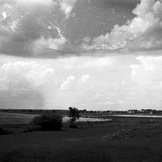Dramatic storm clouds over open countryside.