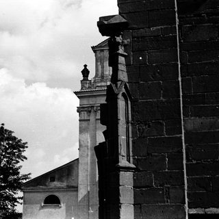 Black-and-white view of historic stone church tower.