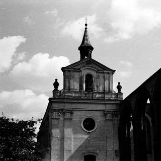 Historic church with partially ruined adjacent arches.