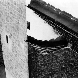 Damaged roof and wall corner.