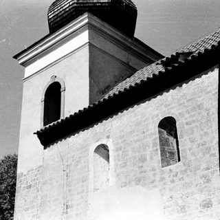 Historic stone church with bell tower.