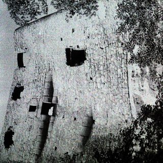 Abandoned stone building with damaged walls.