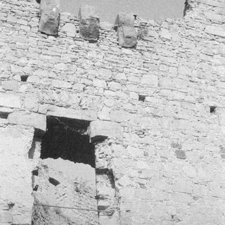 Stone wall with ancient jars on top.
