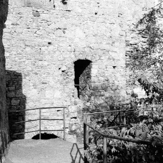 Stone staircase with handrail in ancient ruins.