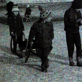 Children playing and walking in snowy urban residential area.