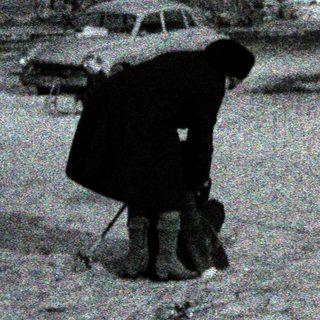 Snowy street scene with person shoveling snow.