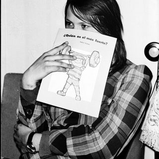 Person holds sign asking "Who is the strongest?" with a drawing of a robot.