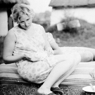 Two women sitting outdoors, engaged in conversation.