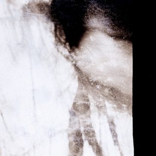 Blurry close-up of a person's arm and shoulder.