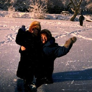Two people ice skating under shooting stars.