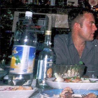 Family enjoying meal at dimly lit restaurant.