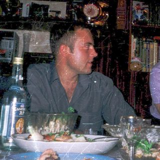 Family enjoying meal at dimly lit restaurant.