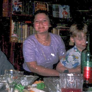 Family enjoying meal at dimly lit restaurant.