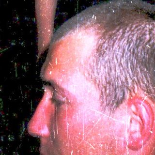 Woman standing in shower with man looking up.