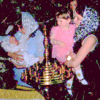 Children playing with sparklers at nighttime celebration.
