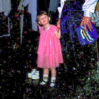 Family in dark, dimly lit indoor space with decorative lanterns.