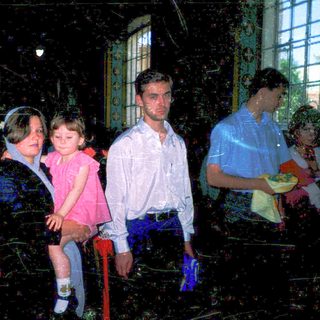Family group indoors during evening event.