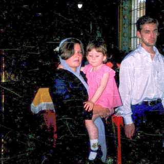 Family group indoors during evening event.