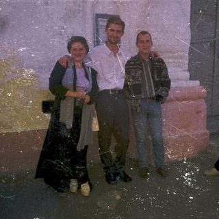 Flooded street with four people standing in water.