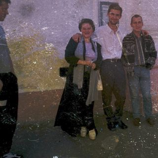 Flooded street with four people standing in water.