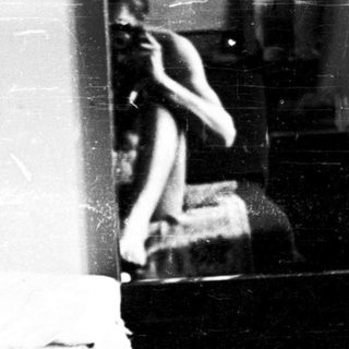 Shirtless child with visible scars indoors.