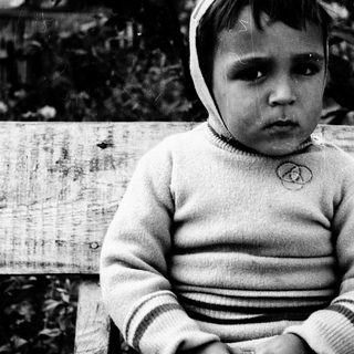 Young child wearing striped sweater and knit hat.