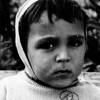 Young child wearing striped sweater and knit hat.