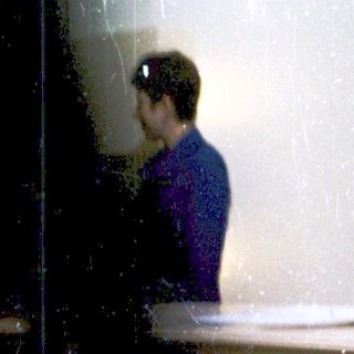 Person standing alone in flooded bathroom area.