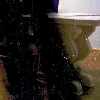 Person standing alone in flooded bathroom area.
