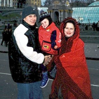 Family posing in Independence Square, Kyiv, winter.