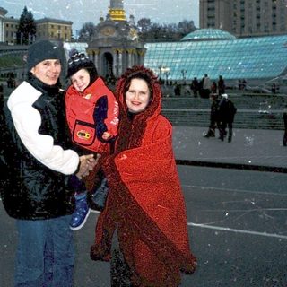 Family posing in Independence Square, Kyiv, winter.