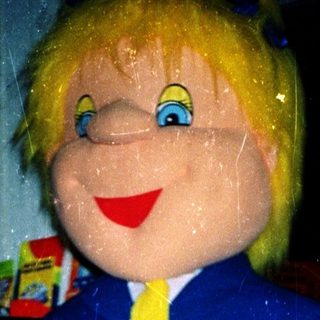 Large mascot figure with child in red jacket.