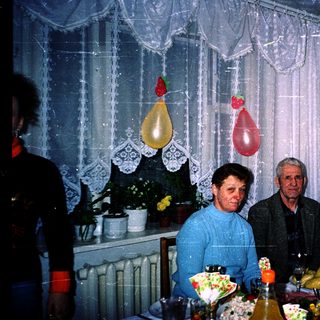 Family celebration with birthday decorations and food.