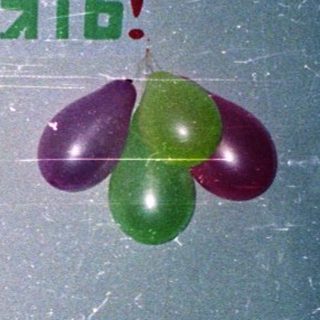 Family celebrating 45th birthday with balloons and drinks.