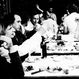 Group gathered outdoors for a meal.