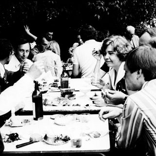 Group gathered outdoors for a meal.