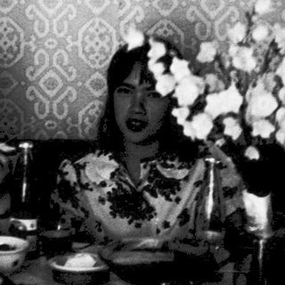 Three women seated at a formal dinner table.
