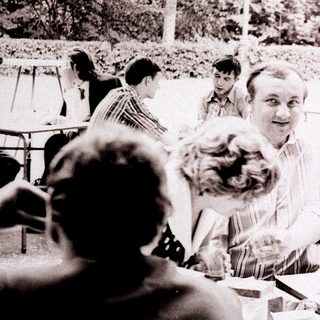 Group of people gathered outdoors at a table.