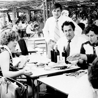 People dining outdoors at a casual restaurant.