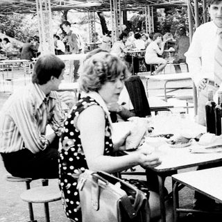 People dining outdoors at a casual restaurant.