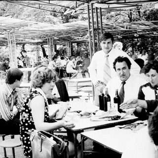 People dining outdoors at a casual restaurant.