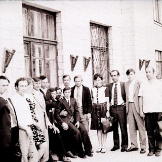 Group of people posing outside a building in the 1970s–1980s.