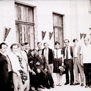 Group of people posing outside a building in the 1970s–1980s.